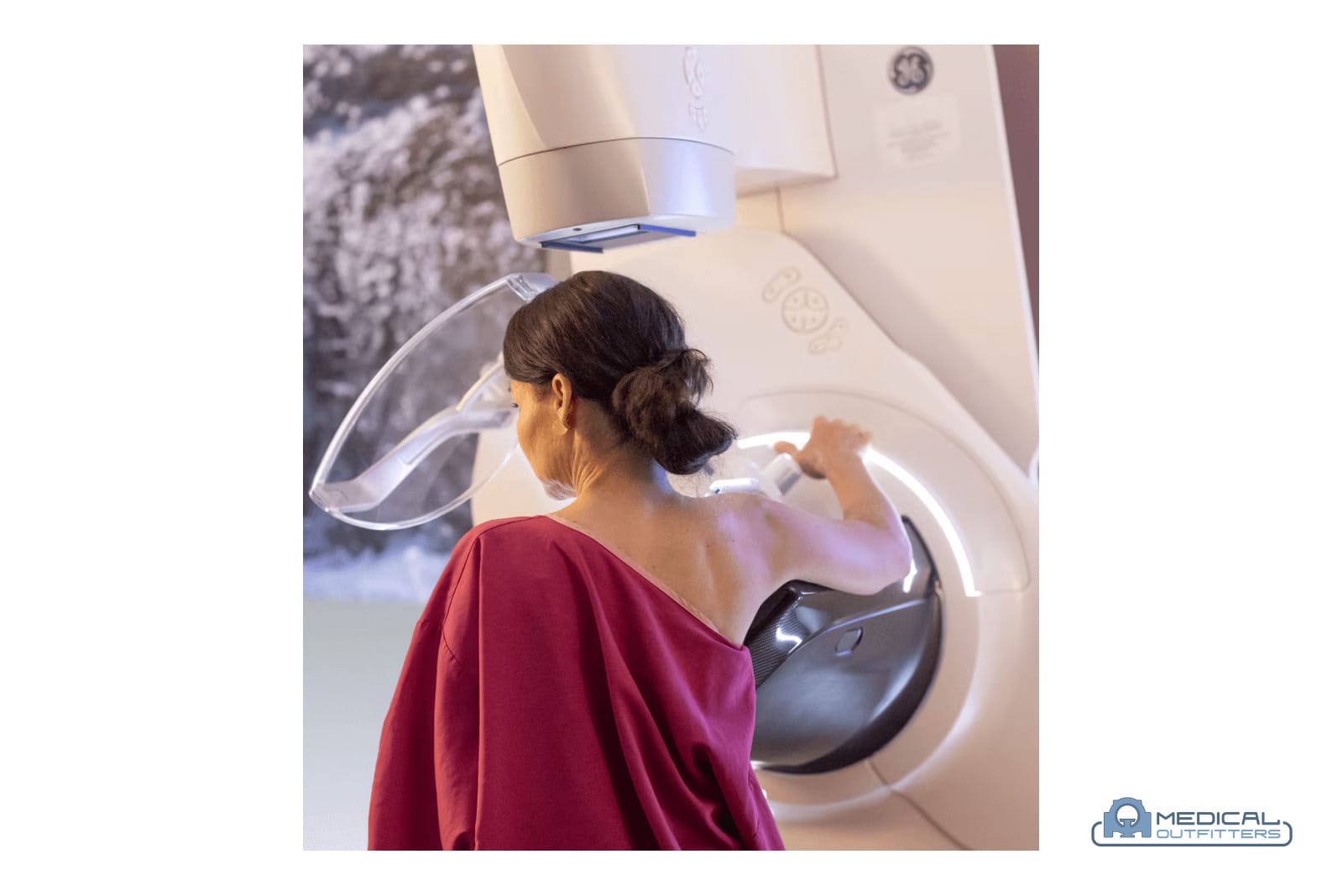 Patient positioned at a GE HealthCare Senographe Pristina mammography system, photo courtesy of GE HealthCare, with the Medical Outfitters watermark