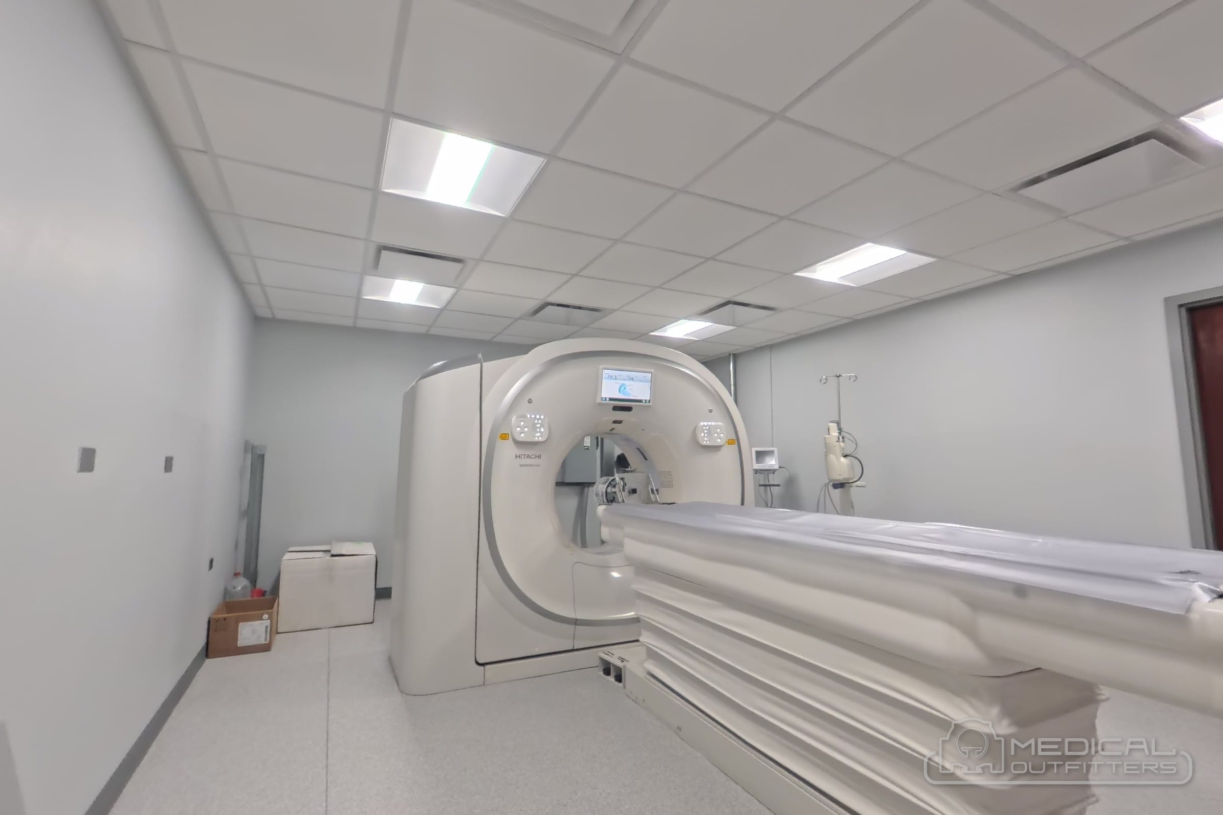 Side view of a Fujifilm CT scanner installed by Medical Outfitters, showing the gantry and patient table in the finished suite