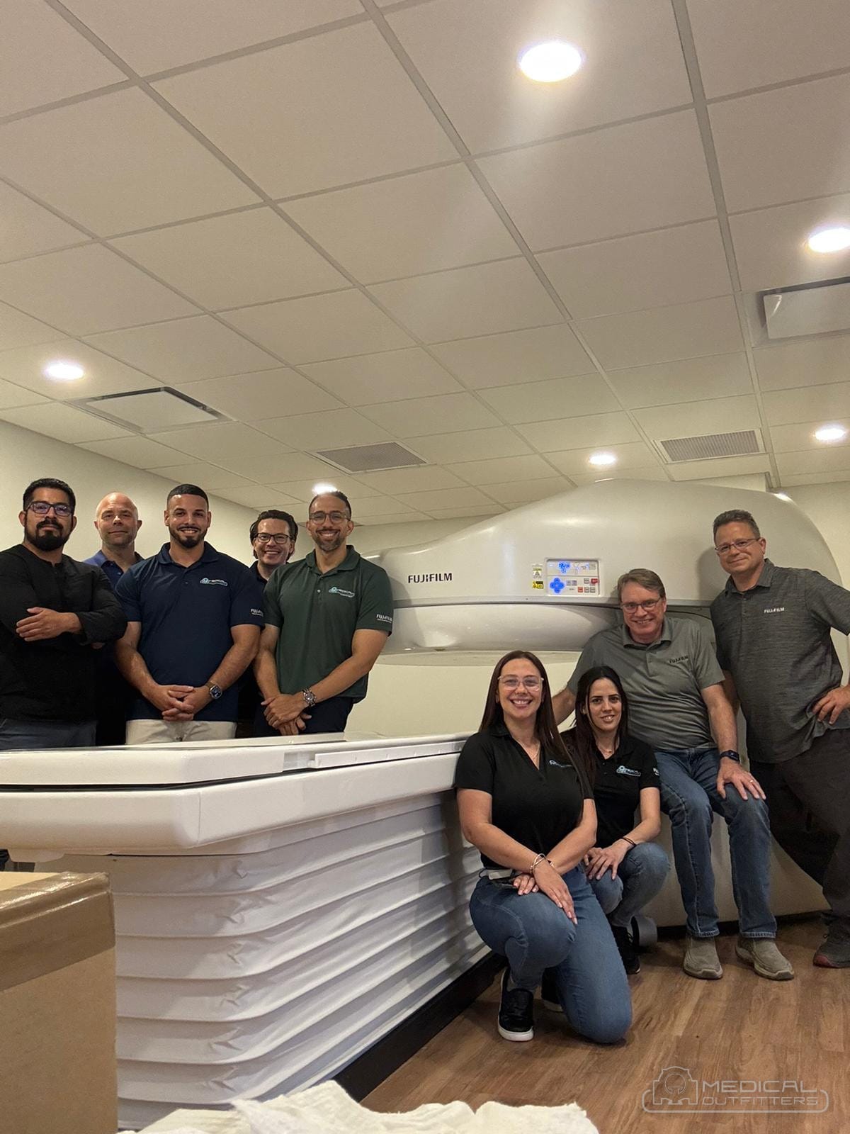 Medical Outfitters installation team and customer staff beside a newly installed Fujifilm MRI