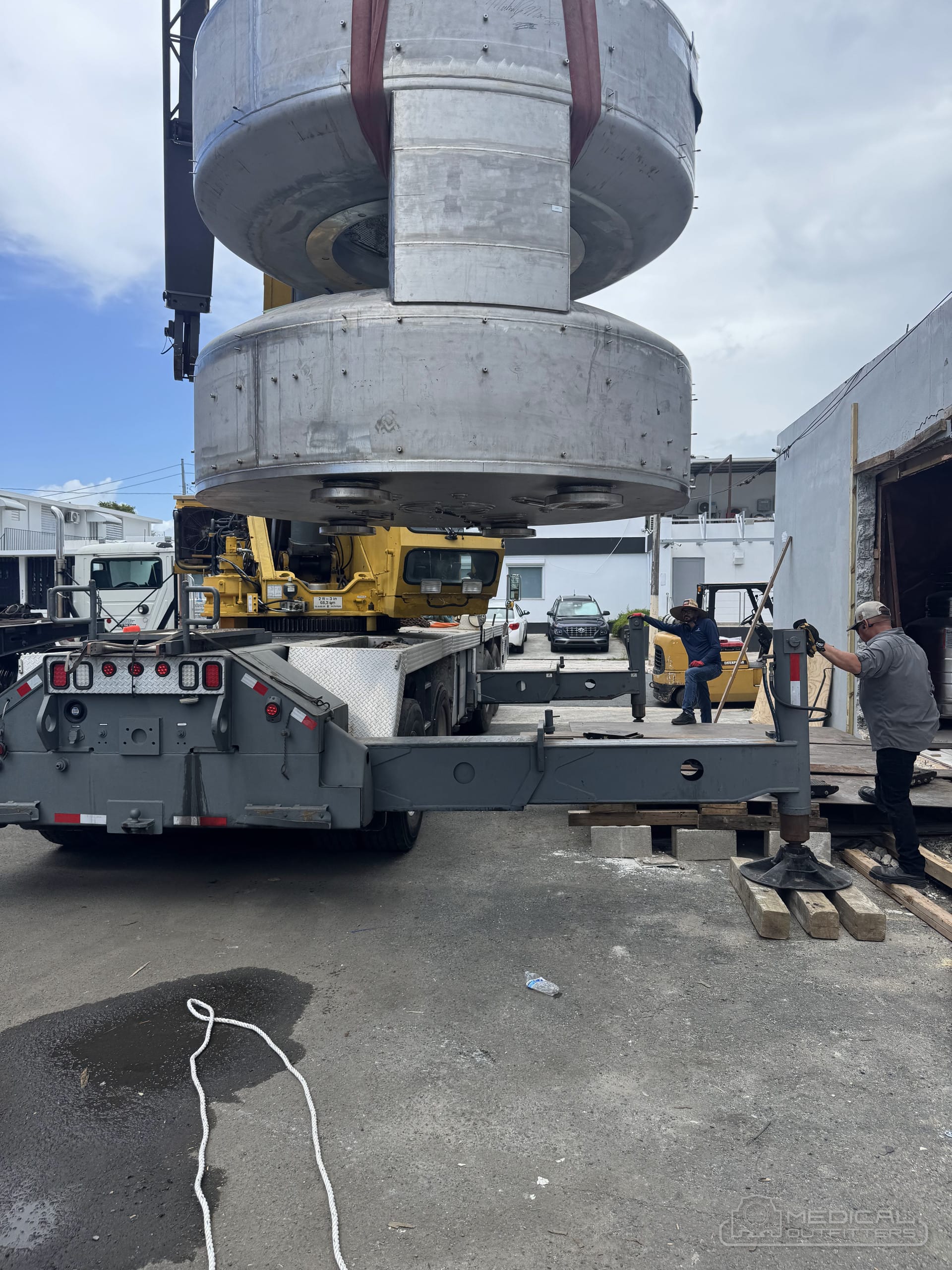 Medical Outfitters crane lift of an open MRI magnet onto a truck