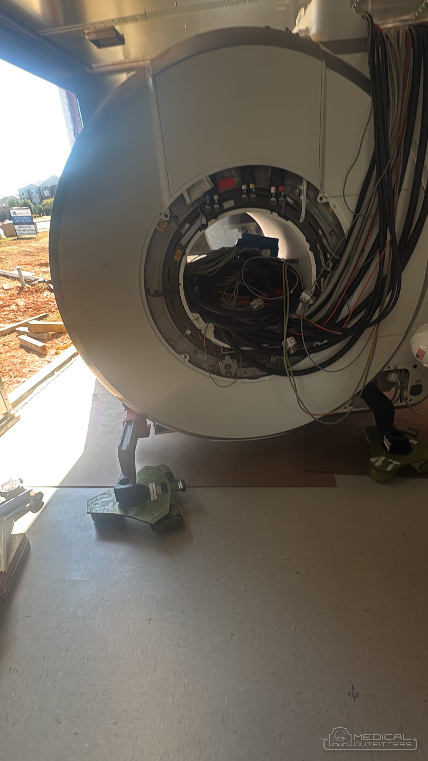 MRI magnet during a Medical Outfitters installation, before the covers go on, showing the cryostat and cabling