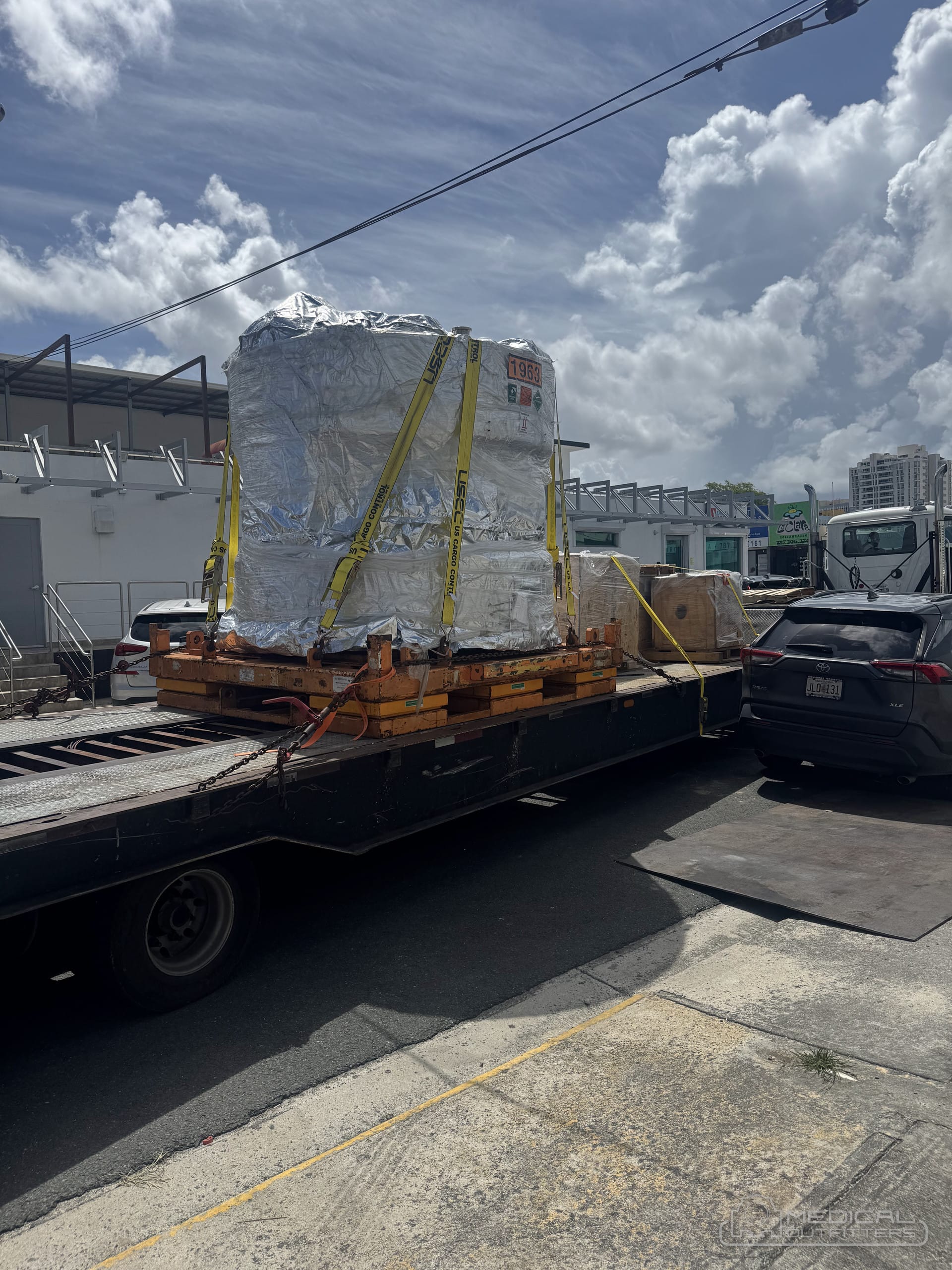 MRI magnet wrapped and strapped on a flatbed for transport by Medical Outfitters