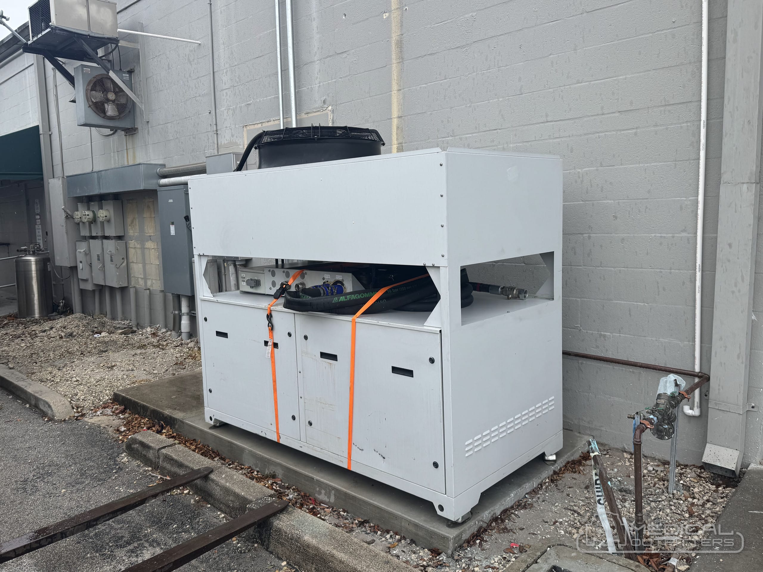 MRI chiller installed on its pad outside the building during a Medical Outfitters installation in Stuart, Florida