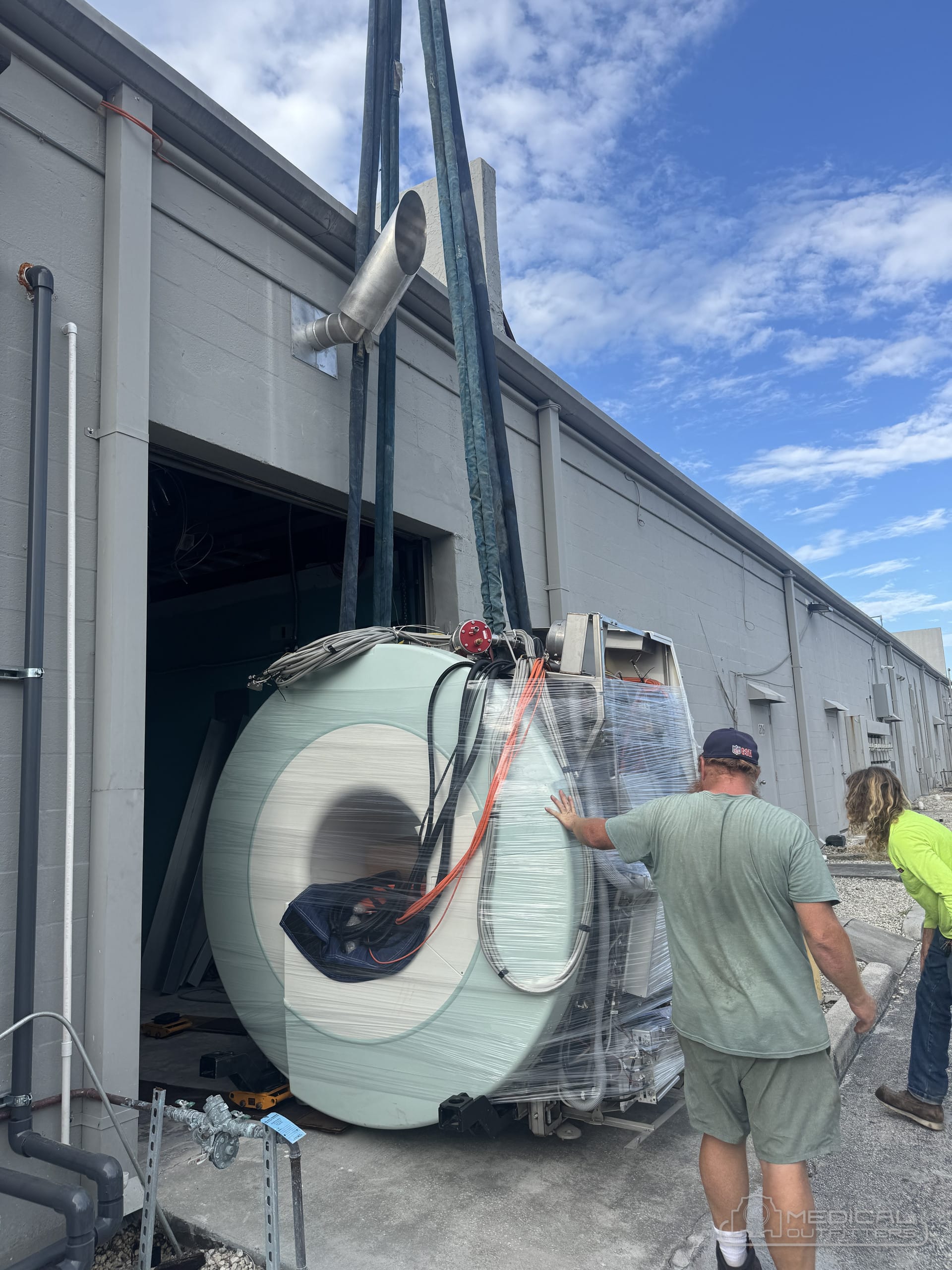 Siemens MAGNETOM Espree MRI magnet on crane straps being guided by the Medical Outfitters crew during delivery in Stuart, Florida