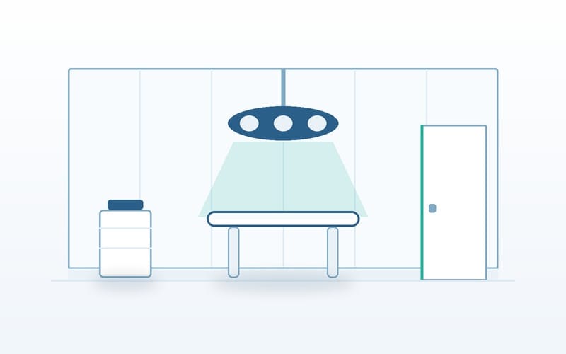 Illustration of a modular cath lab and hybrid operating room: panelled walls, a surgical light over the table and a sealed door