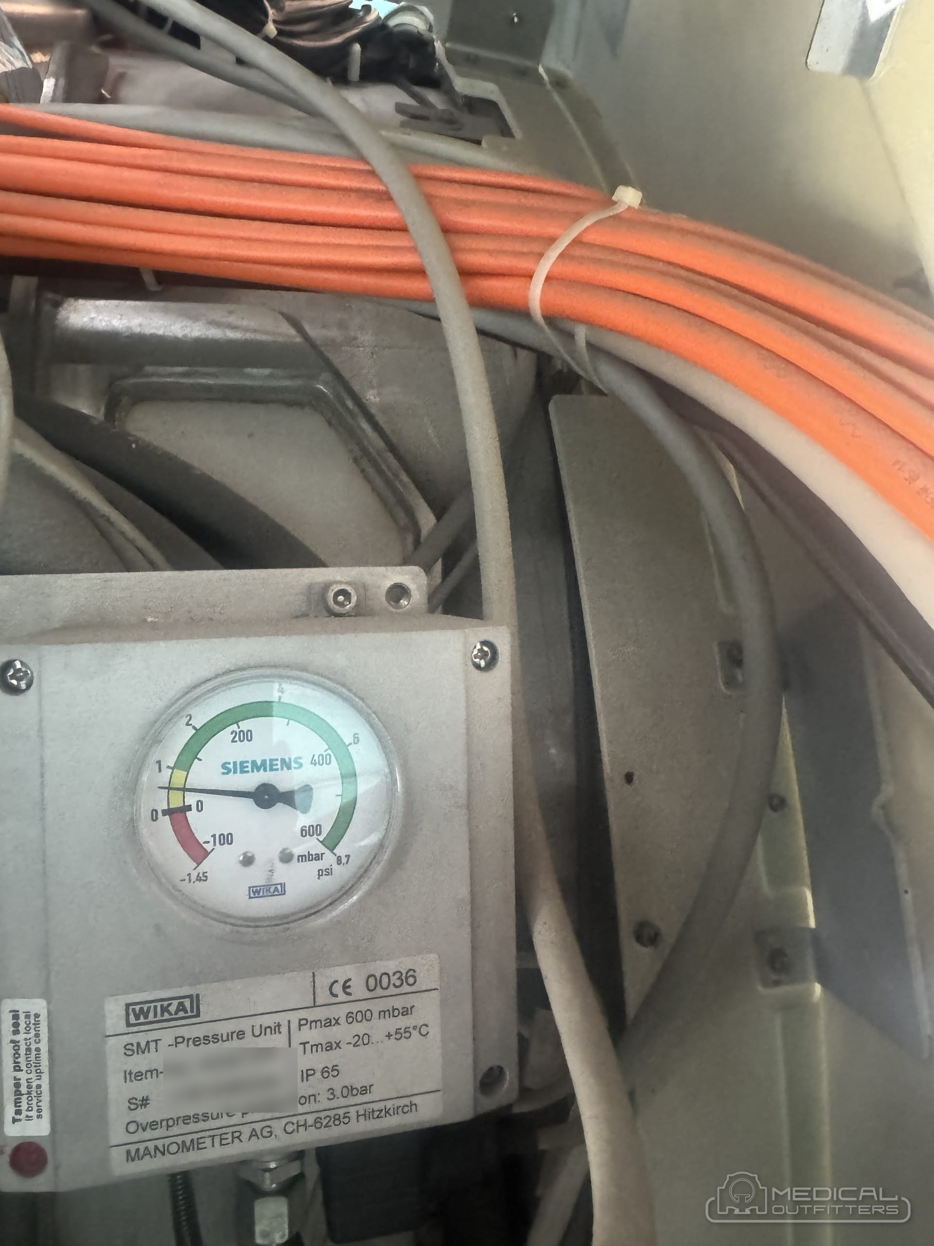 Pressure gauge and cabling on an MRI magnet checked during a Medical Outfitters installation