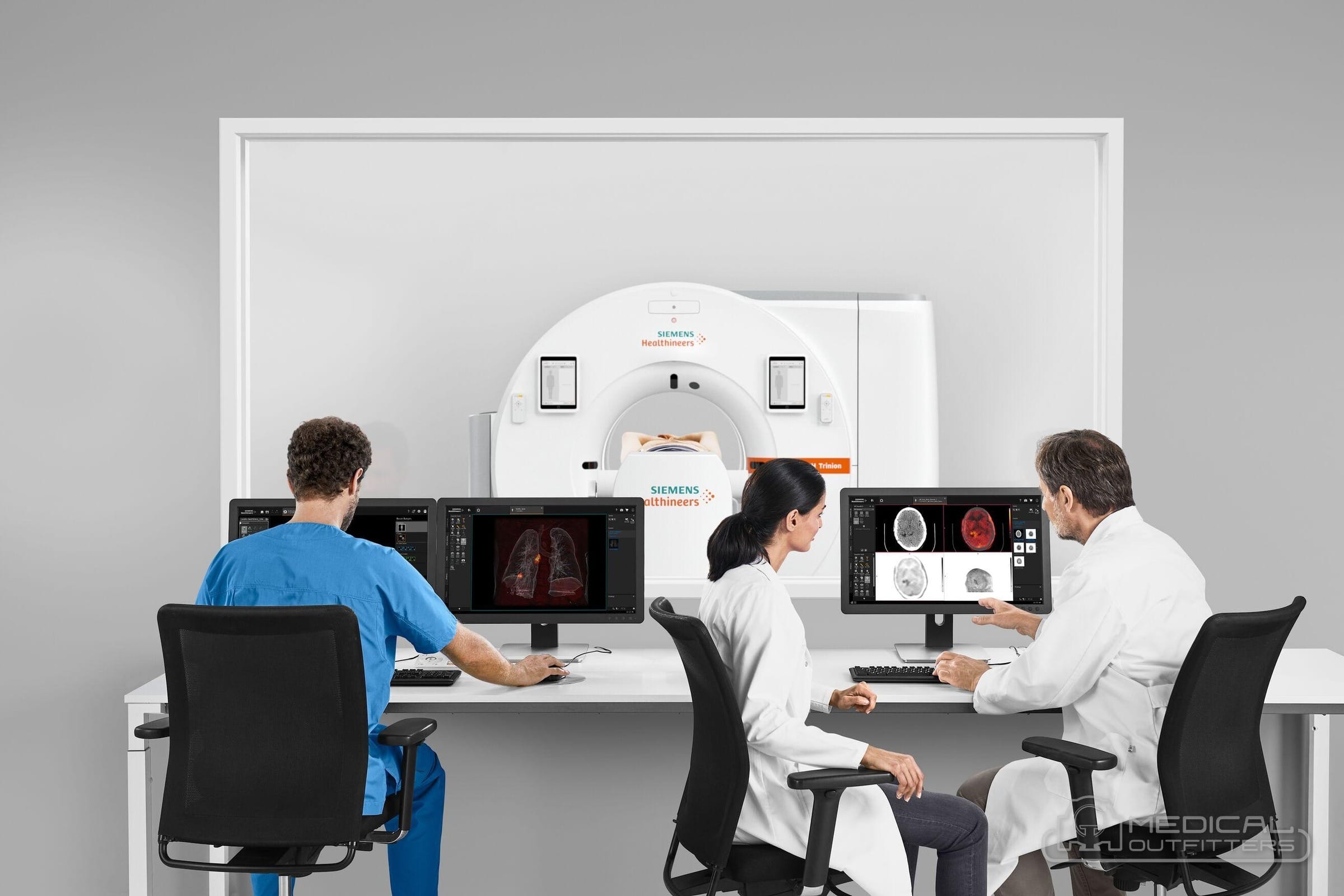 Technologist and two physicians reviewing PET/CT images at workstations in front of a Siemens Biograph Trinion scanner, photo courtesy of Siemens Healthineers