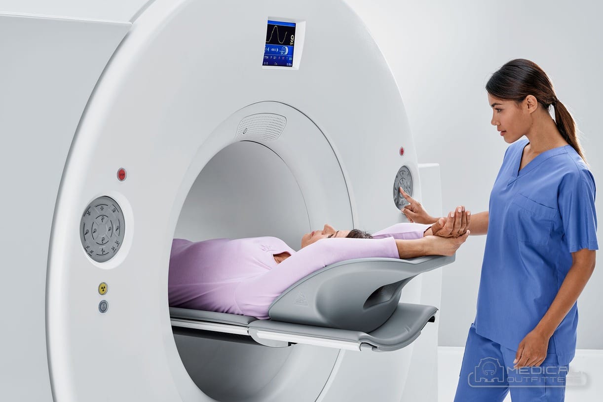 Technologist positioning a patient on a Siemens Biograph Vision PET/CT scanner, photo courtesy of Siemens Healthineers, with the Medical Outfitters watermark