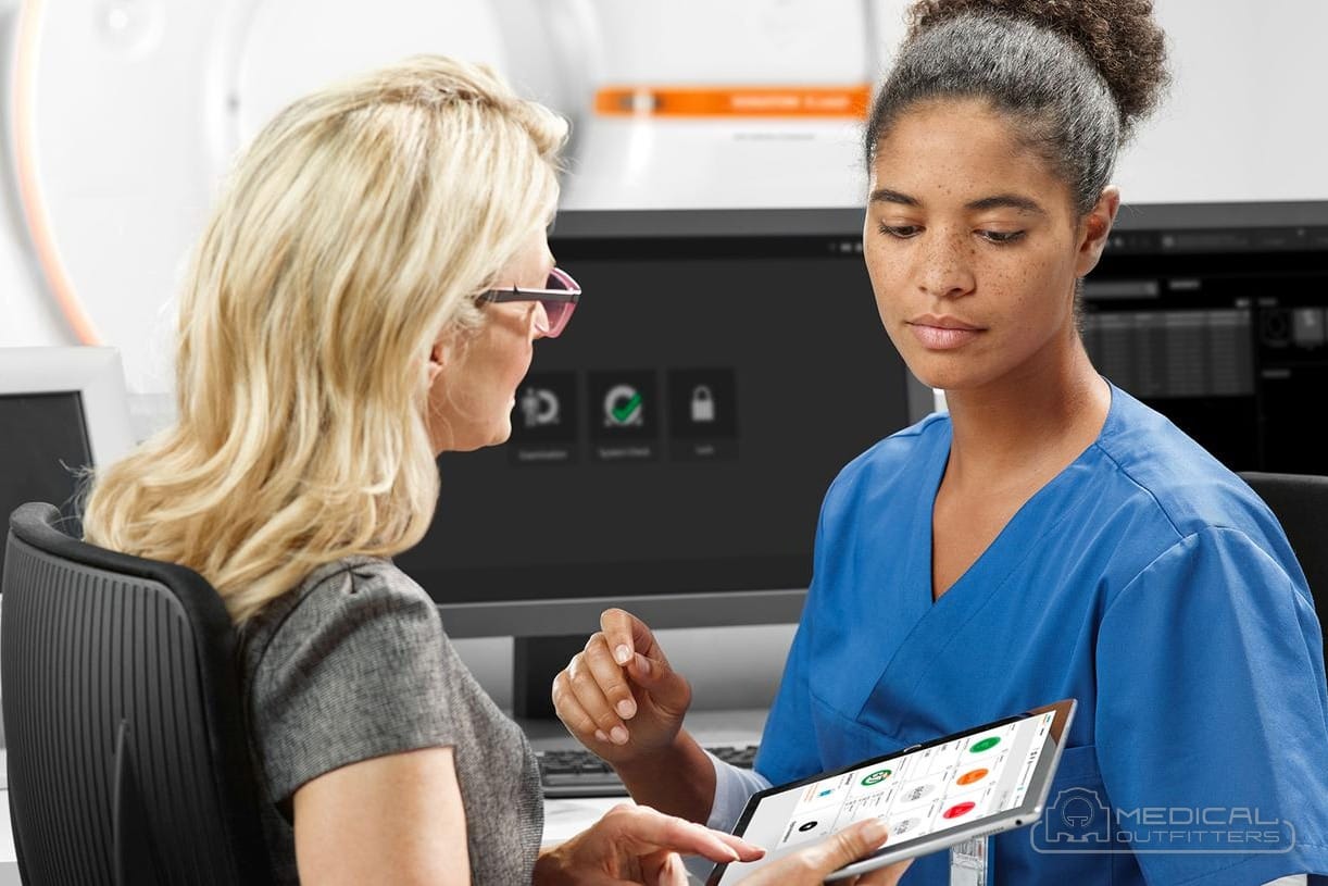 Administrator and technologist reviewing the schedule on a tablet in the control room of a Siemens SOMATOM go CT scanner, photo courtesy of Siemens Healthineers