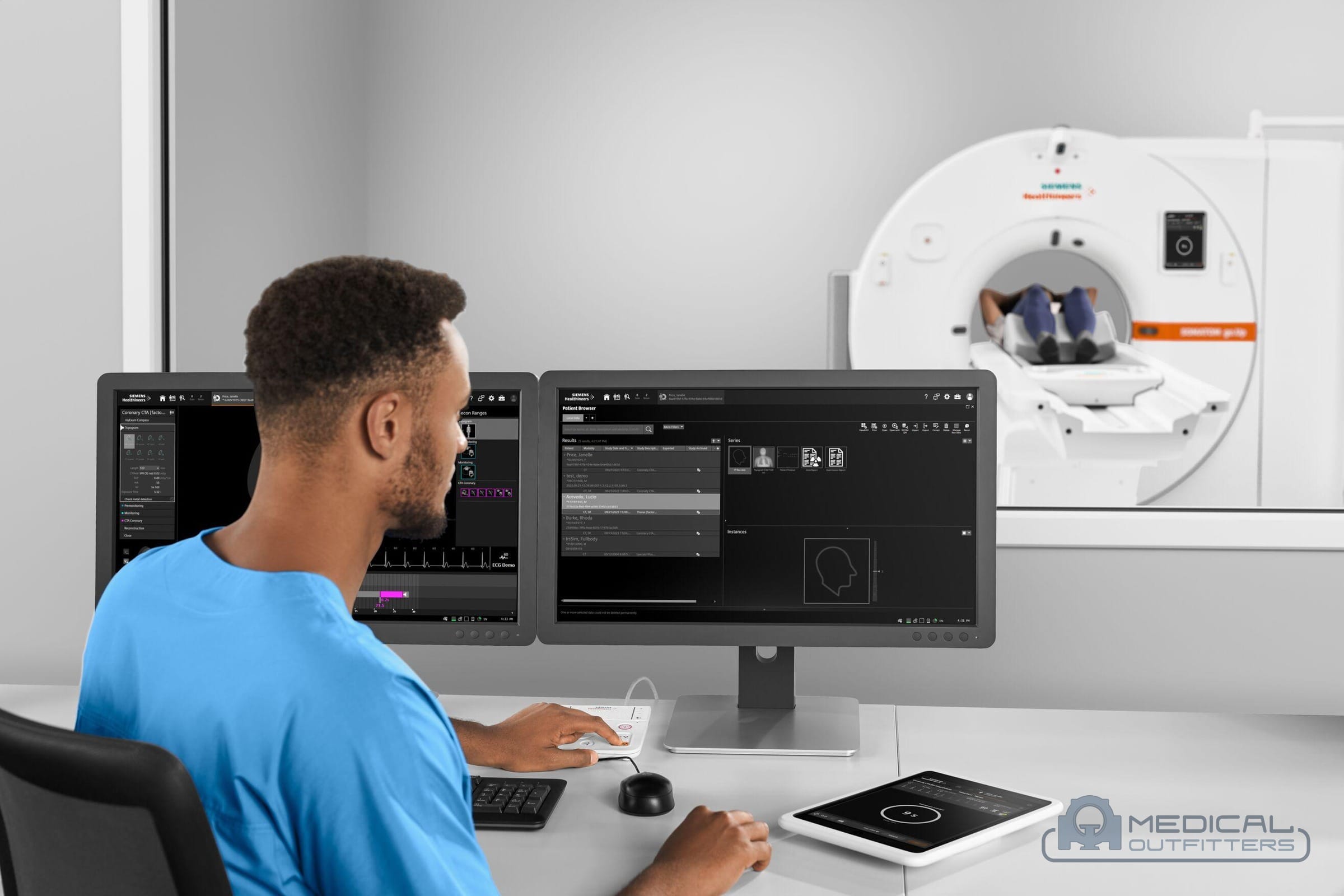 Technologist at the acquisition console with a Siemens SOMATOM go.Up CT scanner and patient behind the window, photo courtesy of Siemens Healthineers